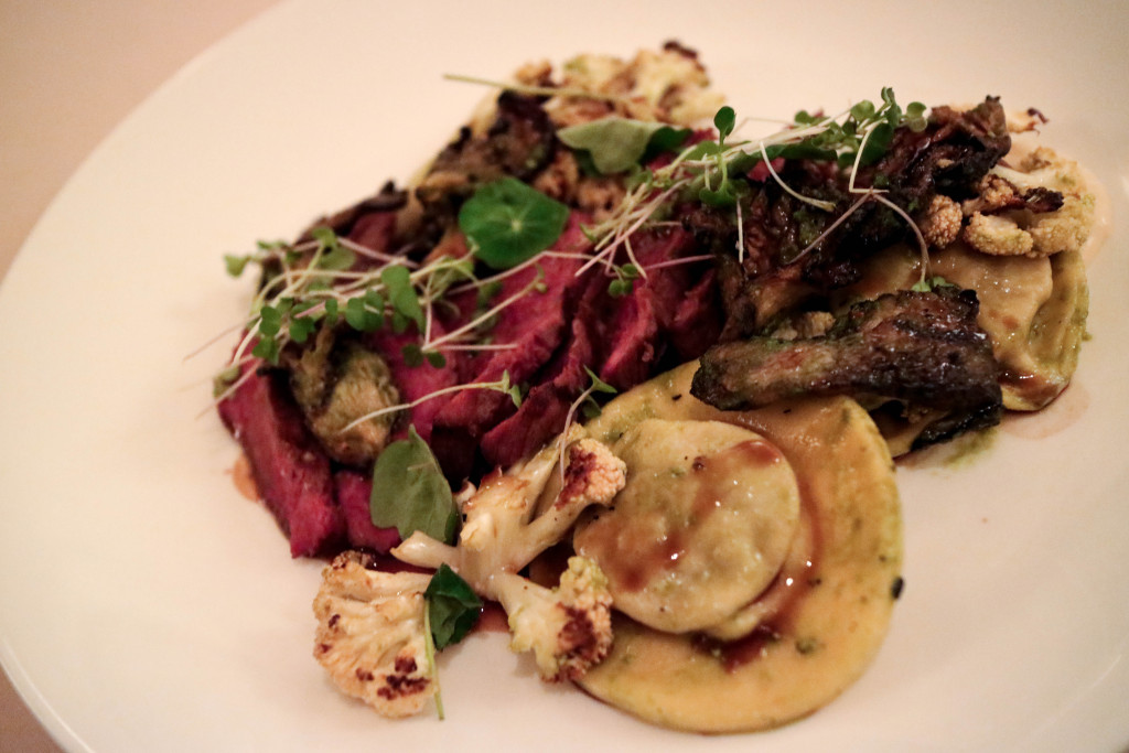 Grilled steak, beef ravioli, charred cauliflower, smoked oyster mushrooms from Rouge in Calgary, Canada