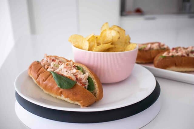 a homemade lobster roll with potato chips