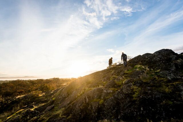 A couple hiking up the tallest point of Mt.Tolmie