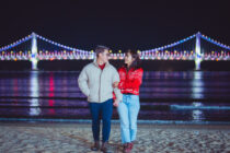 busan beaches couple at night with gwangan bridge in the background
