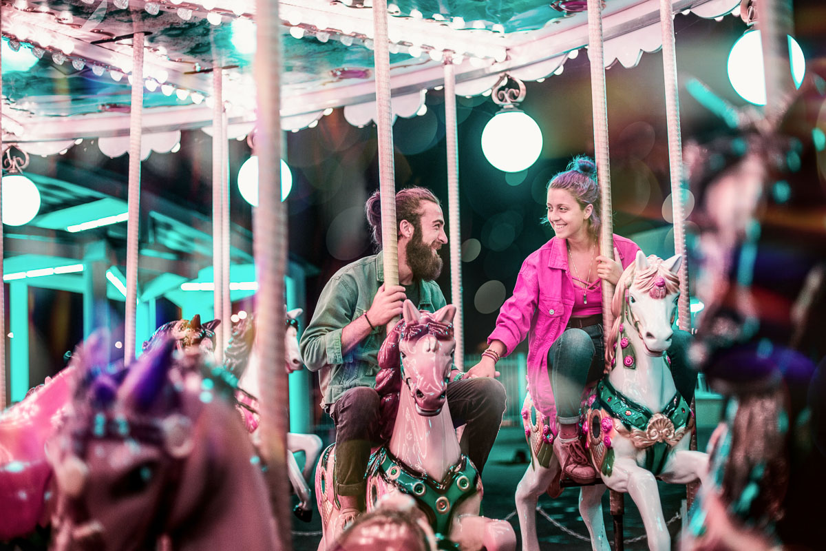 a couple enjoying date night on a merry go round